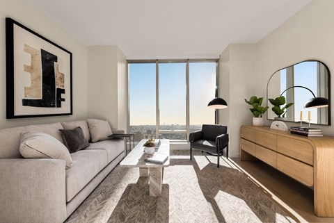 a living room with a large window and a couch and a table